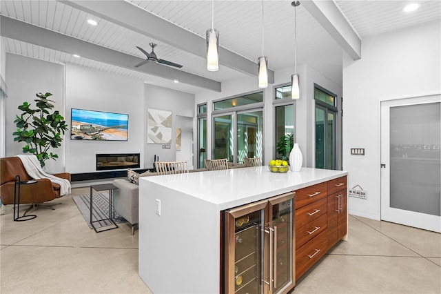 kitchen with wine cooler, decorative light fixtures, a center island, ceiling fan, and beam ceiling