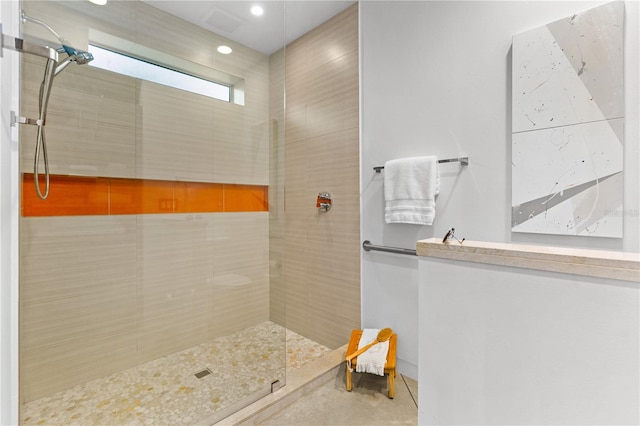 bathroom with a tile shower