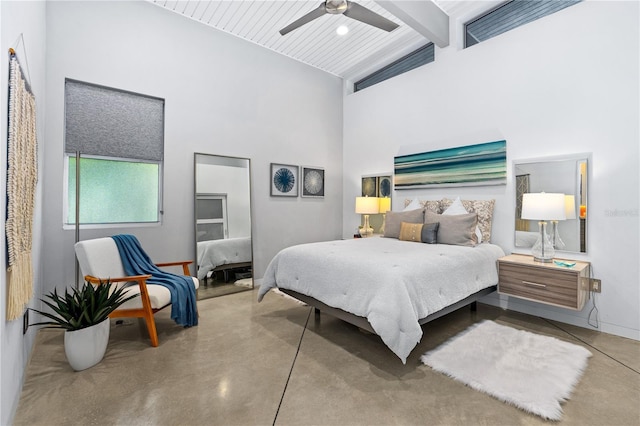 bedroom with ceiling fan, concrete floors, beamed ceiling, and a high ceiling