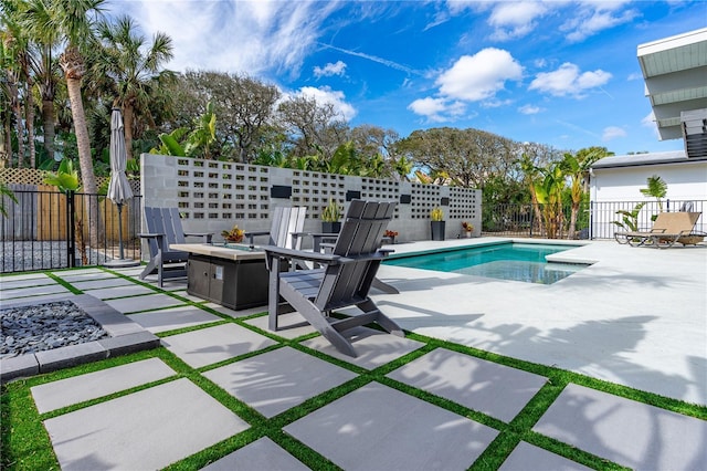 view of pool with a patio area and a fire pit