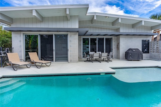 view of swimming pool with area for grilling and a patio