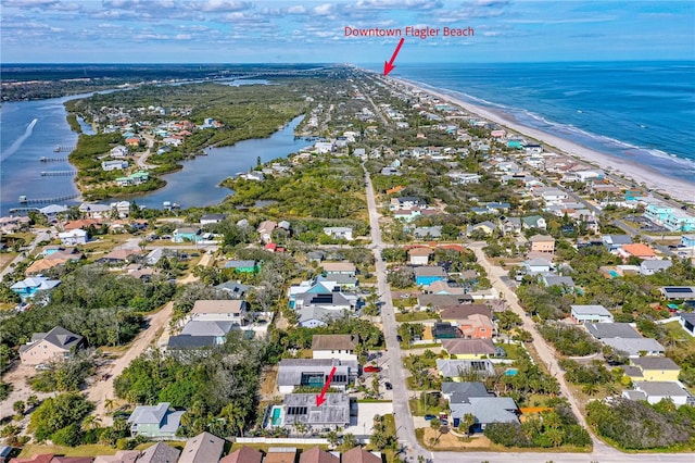 bird's eye view with a water view and a beach view