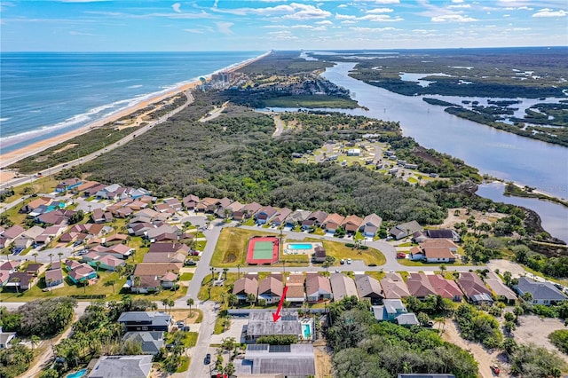 aerial view with a water view and a beach view