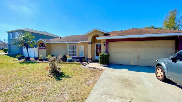 ranch-style house with a garage and a front yard