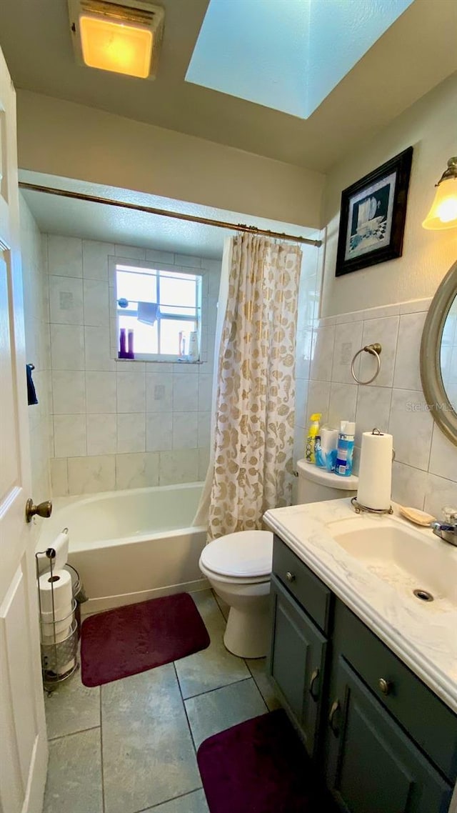 full bathroom featuring vanity, tile walls, shower / tub combo, and toilet