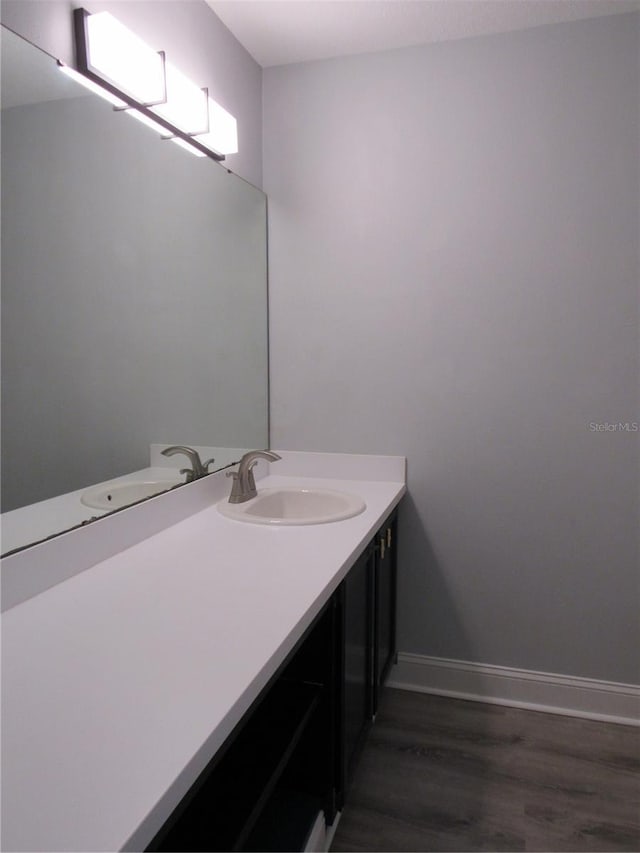 bathroom with vanity and wood-type flooring