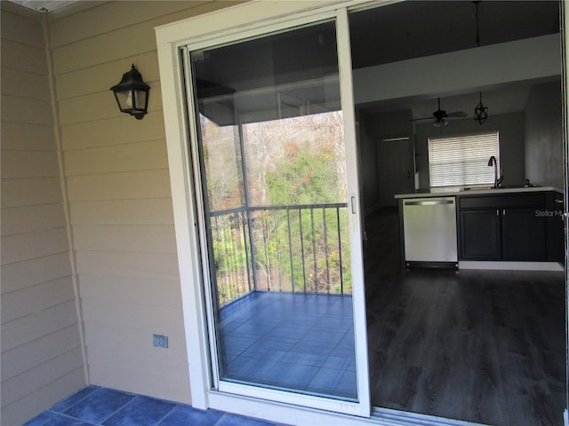 entryway with wooden walls, dark hardwood / wood-style flooring, and sink