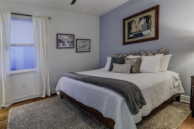 bedroom featuring hardwood / wood-style floors and ceiling fan