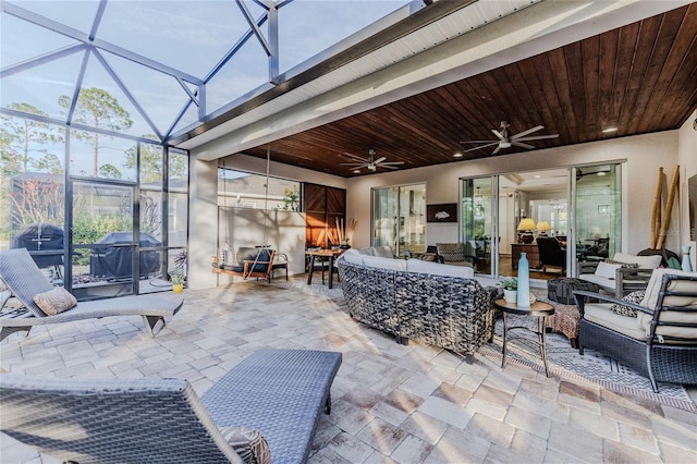 view of patio with ceiling fan, an outdoor living space, a lanai, and grilling area