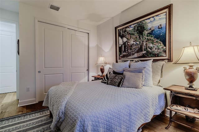 bedroom with hardwood / wood-style floors and a closet