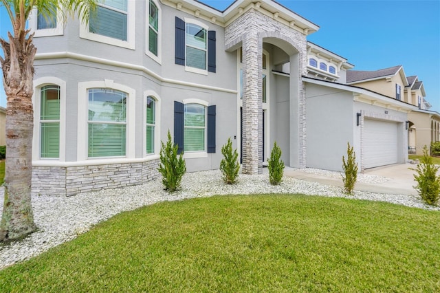 view of front of home featuring a garage and a front lawn