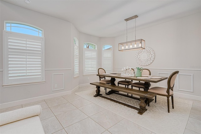 tiled dining area featuring a healthy amount of sunlight