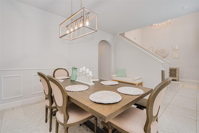 tiled dining area with a notable chandelier