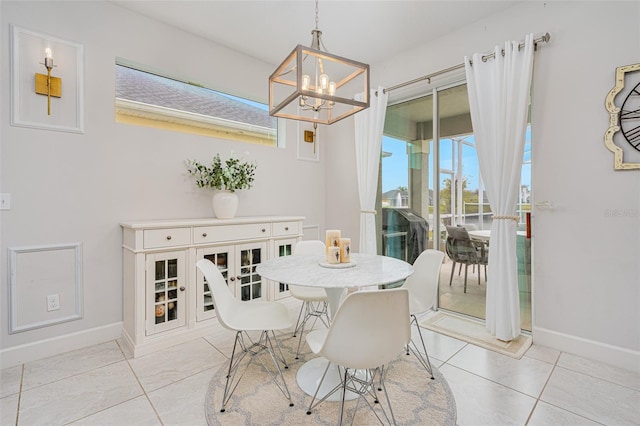 dining area with light tile patterned flooring and a notable chandelier