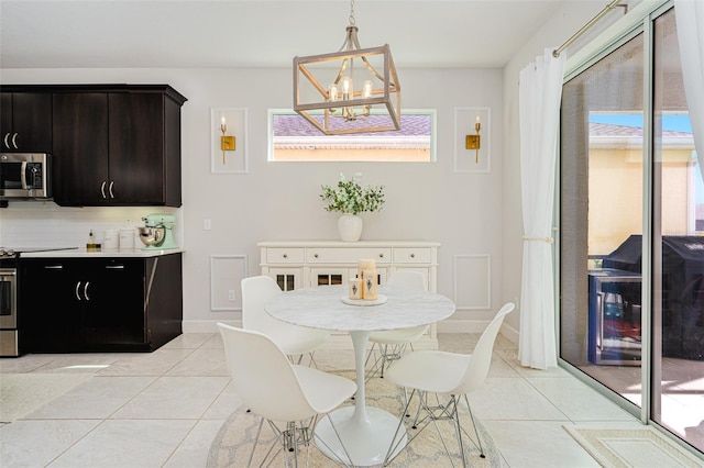 dining area with light tile patterned flooring and an inviting chandelier