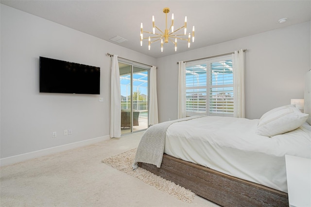 carpeted bedroom featuring a notable chandelier and access to exterior