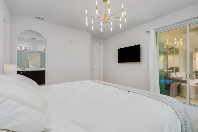 bedroom with a notable chandelier, ensuite bathroom, sink, and access to outside