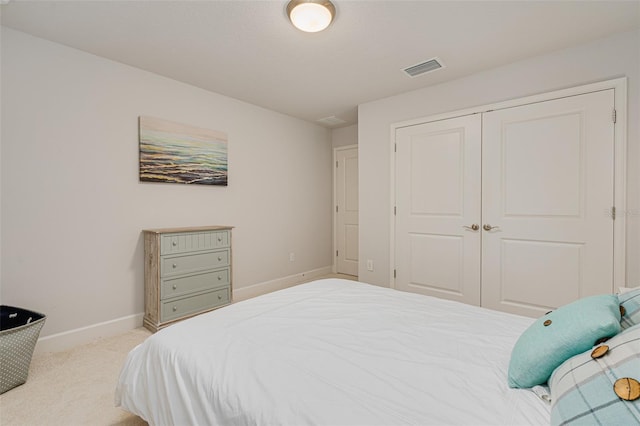 bedroom with light colored carpet and a closet