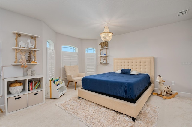 bedroom with an inviting chandelier and carpet flooring