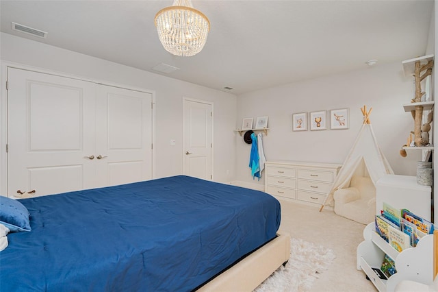 bedroom with an inviting chandelier and carpet floors