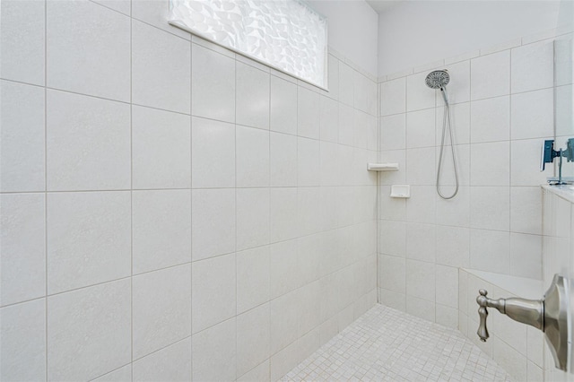 bathroom with tiled shower