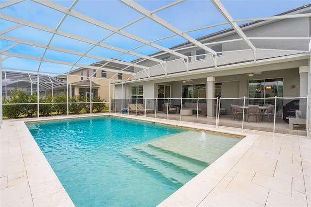 view of swimming pool with a patio and glass enclosure