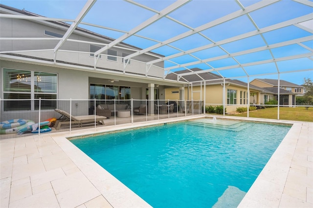 view of swimming pool with outdoor lounge area, a lanai, and a patio area