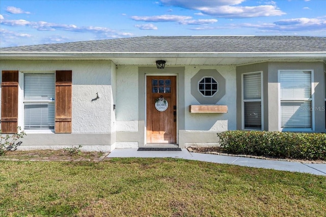 property entrance featuring a lawn