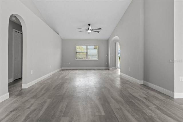 unfurnished living room with vaulted ceiling, ceiling fan, and light hardwood / wood-style floors