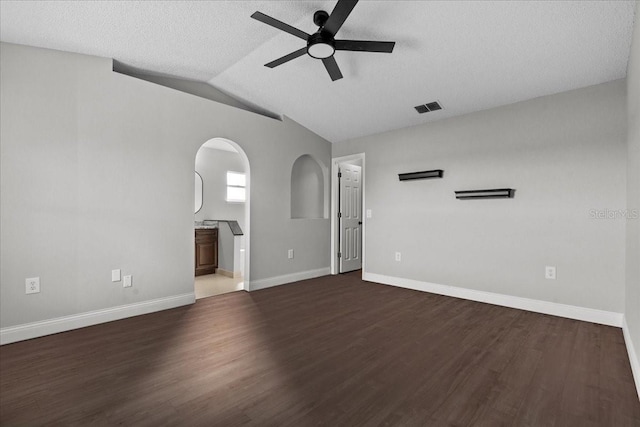 interior space featuring vaulted ceiling, dark hardwood / wood-style floors, a textured ceiling, and ceiling fan