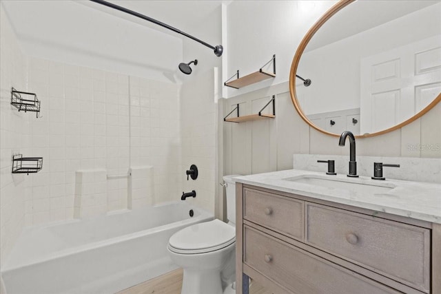 full bathroom featuring vanity, wood-type flooring, toilet, and washtub / shower combination