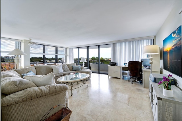 living room featuring ceiling fan and floor to ceiling windows