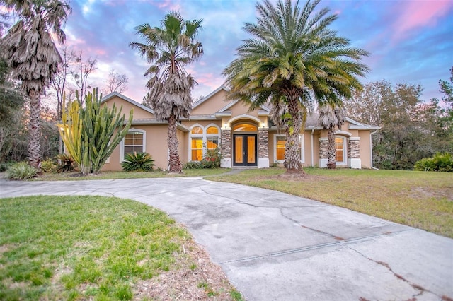 view of front of property featuring a yard and french doors