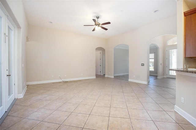 unfurnished room featuring ceiling fan and light tile patterned flooring