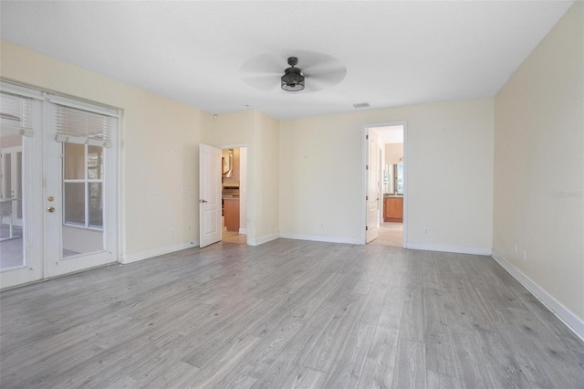 empty room with french doors, ceiling fan, and light hardwood / wood-style floors