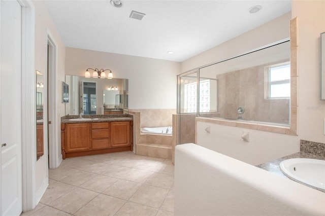 bathroom featuring vanity, tile patterned flooring, and plus walk in shower