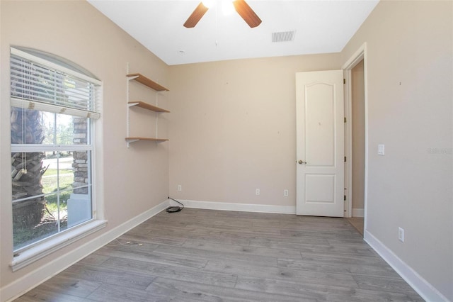 spare room featuring light hardwood / wood-style flooring and ceiling fan