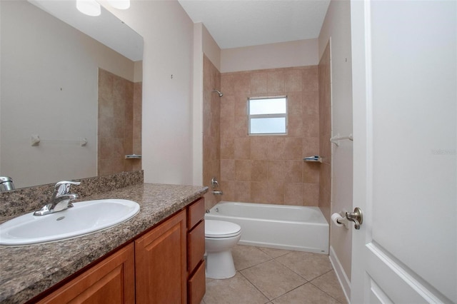 full bathroom featuring tile patterned flooring, vanity, tiled shower / bath combo, and toilet