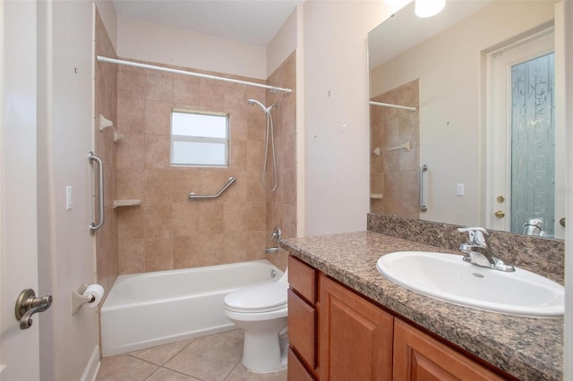 full bathroom featuring vanity, tiled shower / bath, tile patterned flooring, and toilet