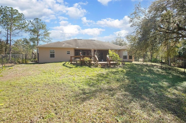 back of house with a yard and a deck