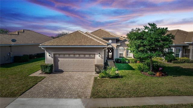 view of front facade featuring a garage and a yard