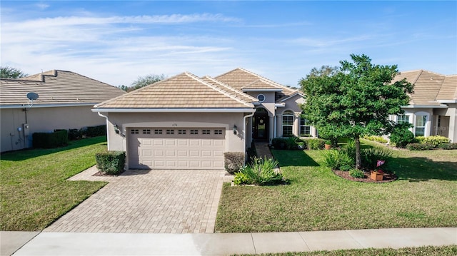 view of front facade with a garage and a front lawn