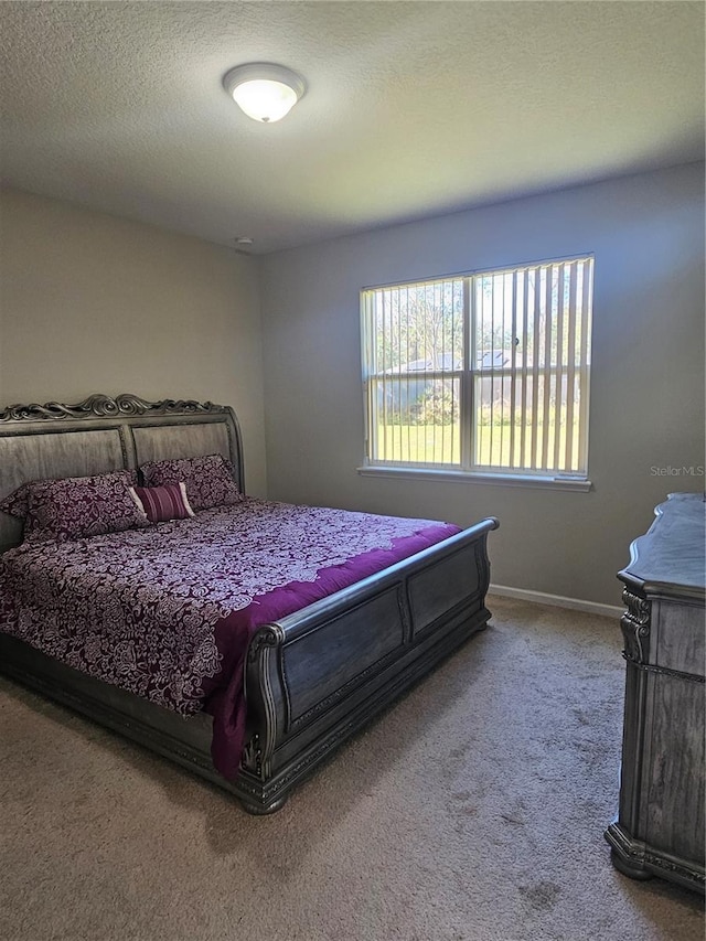 bedroom featuring carpet floors and a textured ceiling