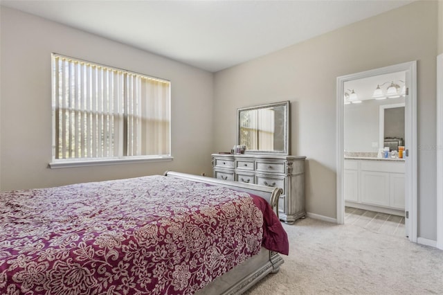 carpeted bedroom with connected bathroom and multiple windows