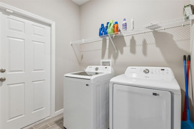 clothes washing area with washing machine and clothes dryer