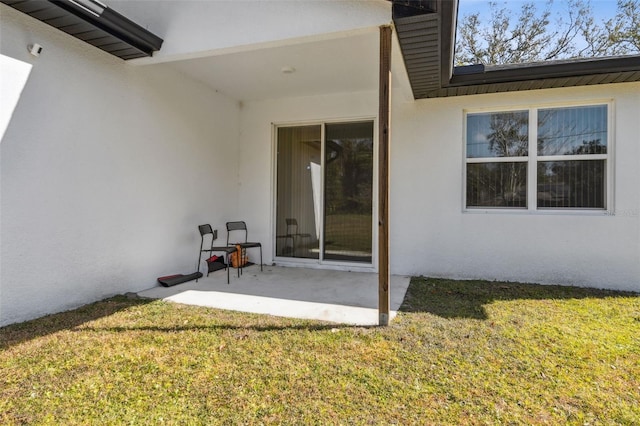 rear view of property featuring a patio and a lawn