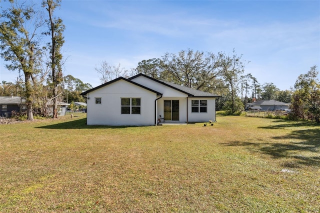 back of property featuring a lawn