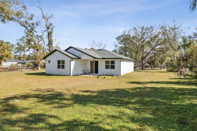 rear view of house with a lawn