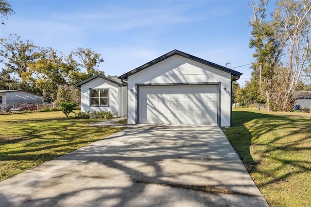 ranch-style house featuring a garage and a front lawn