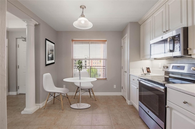 kitchen featuring appliances with stainless steel finishes, decorative columns, white cabinetry, hanging light fixtures, and light tile patterned floors